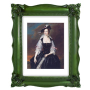 A vintage picture frame with hand-carved floral details in dark green, displayed around a portrait painting.