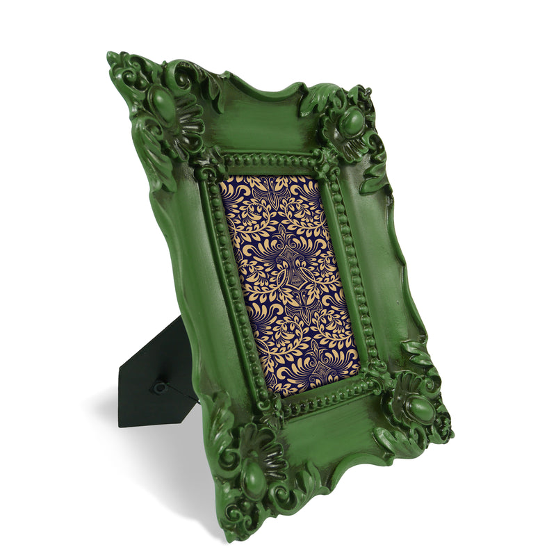 A baroque-style picture frame in dark green color. The frame is designed for wall and tabletop display.