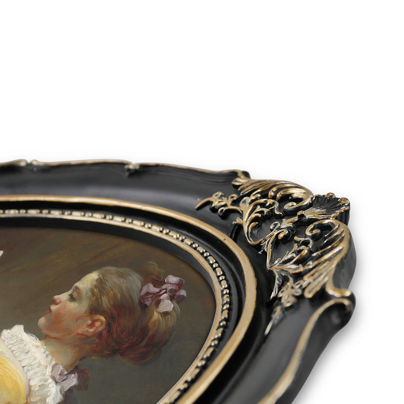 An oval-shaped black picture frame with embossed flourish details. It is designed for both wall and tabletop display.
