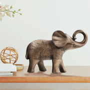A elephant sculpture standing 6 inches tall, features a rich bronze finish with hand-painted details that highlight its artistry.