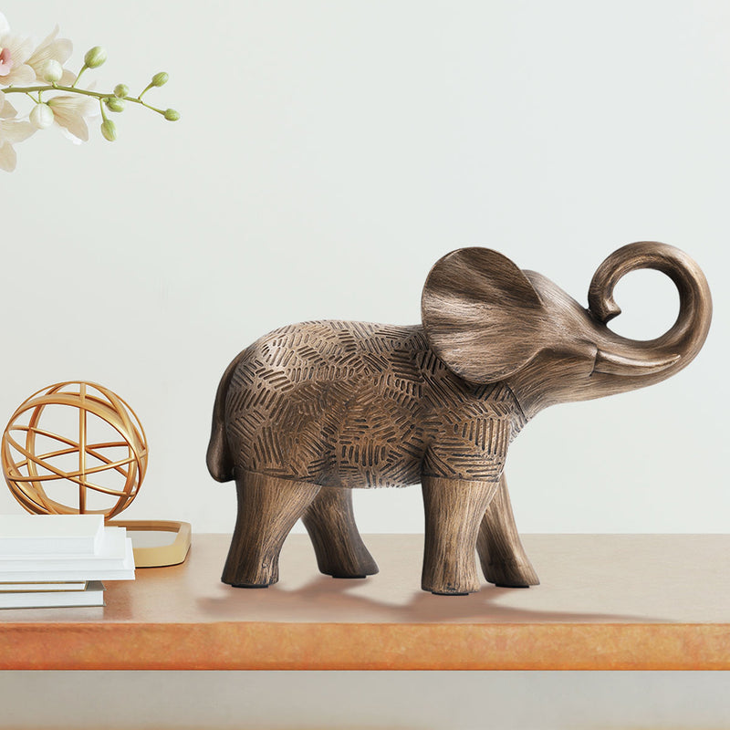 A elephant sculpture standing 6 inches tall, features a rich bronze finish with hand-painted details that highlight its artistry.