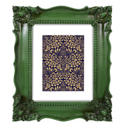 A vintage picture frame with hand-carved floral details in dark green, displayed around a portrait painting.