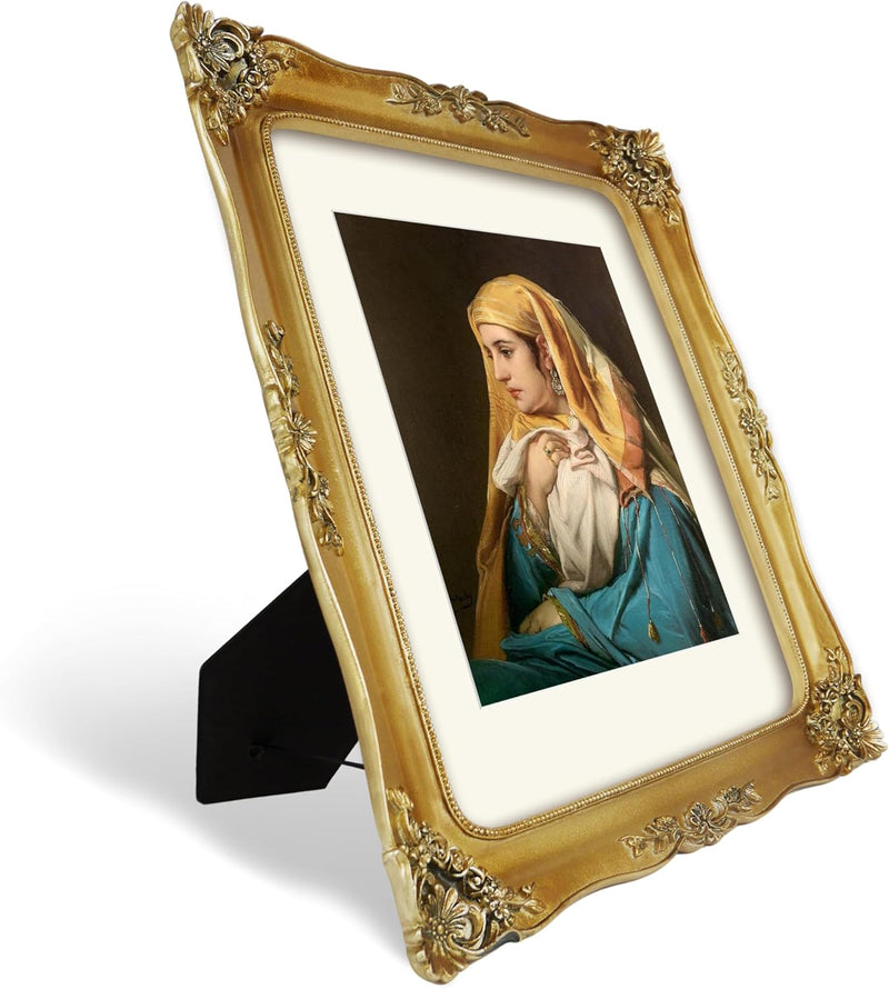 Decorative gold picture frame with a portrait of a woman on a white background.