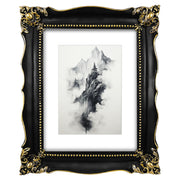 An ornate black picture frame with gold accents, displaying a mountain range artwork.