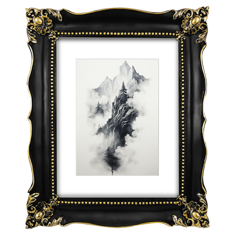 An ornate black picture frame with gold accents, displaying a mountain range artwork.