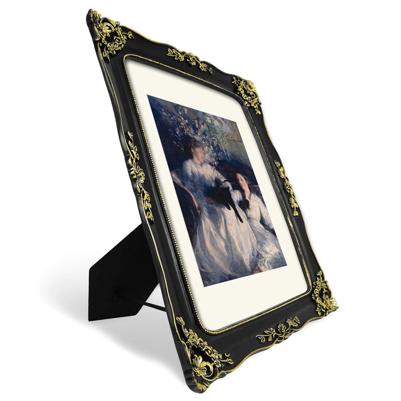 Decorative black and gold picture frame with a portrait inside on a white background.