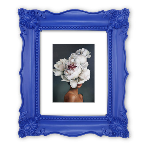A blue picture frame with a decorative design, displaying a picture of a floral arrangement inside.