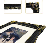 Decorative black and gold picture frame with detailed carvings, displaying a painting inside.