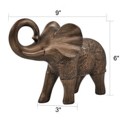 A elephant sculpture standing 6 inches tall, features a rich bronze finish with hand-painted details that highlight its artistry.