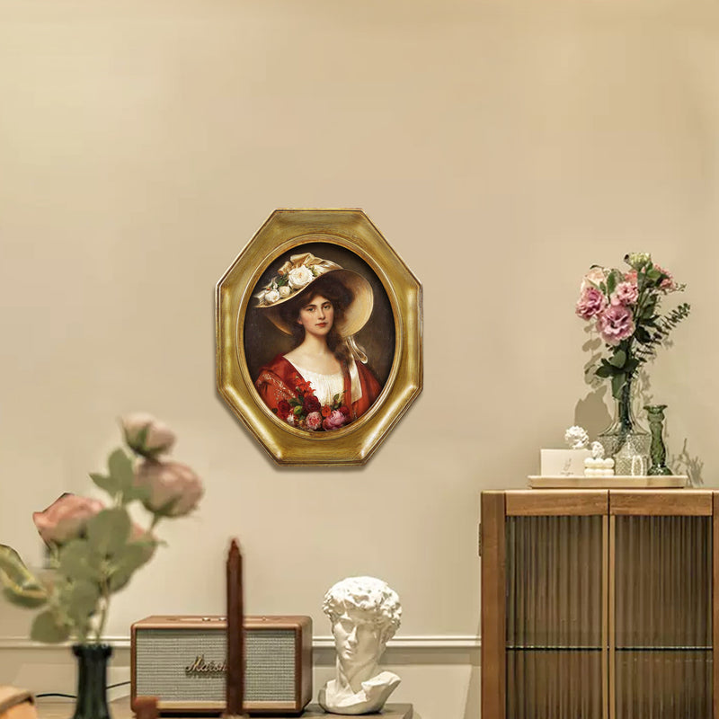 An antique-style octagon picture frame with a brushed gold finish is displayed on a wall.