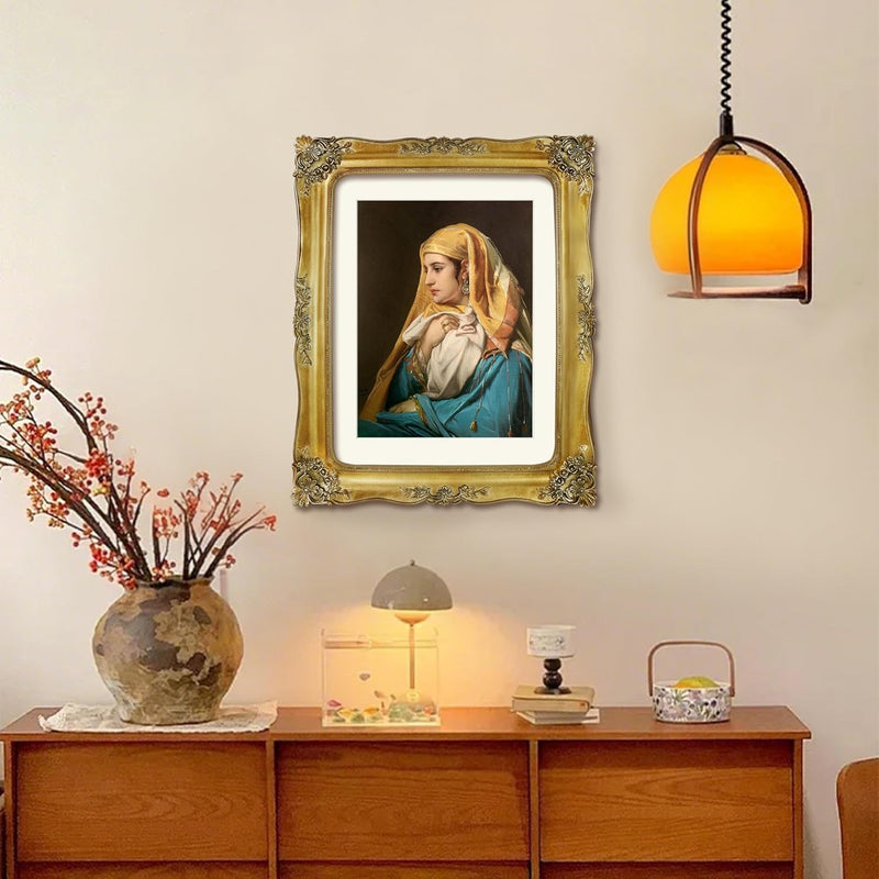 Framed portrait above a wooden cabinet with decorative items.
