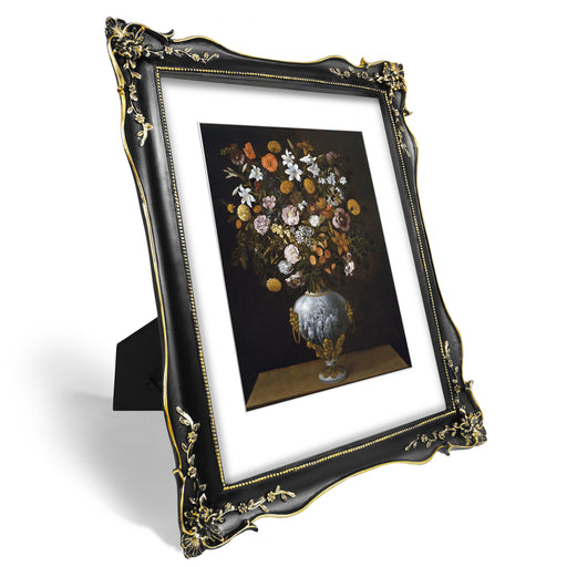 An ornate black picture frame with floral carvings around the border, designed for an 11x14 poster.