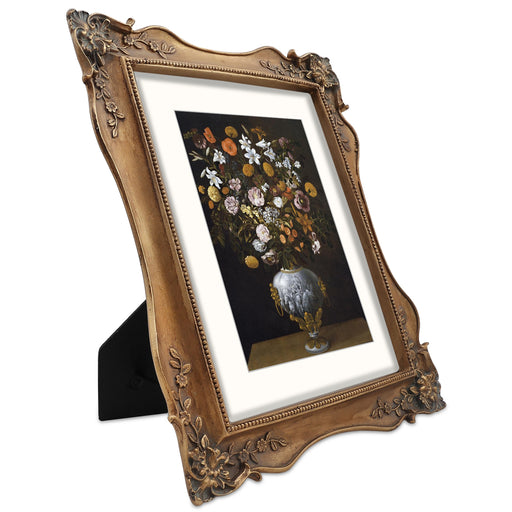 An 8x10 picture frame with floral corner ornaments, designed for tabletop and wall display, made of resin and painted to achieve a vintage look.