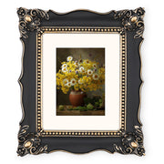 An ornate black picture frame with gold accents, displaying a floral artwork.