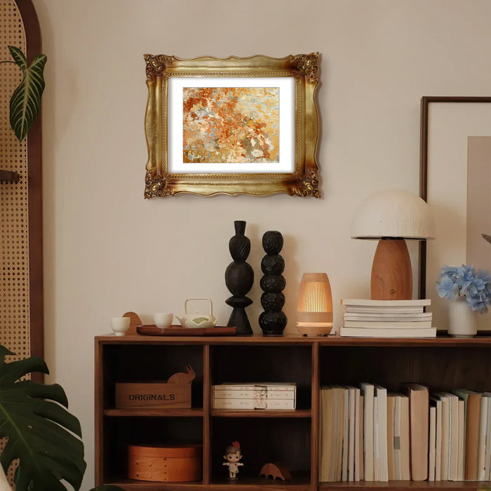 An antique gold picture frame with a white mat.