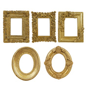 Set of five ornate gold picture frames on a white background