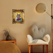 Decorative gold picture frame with intricate patterns hanging on a wall.