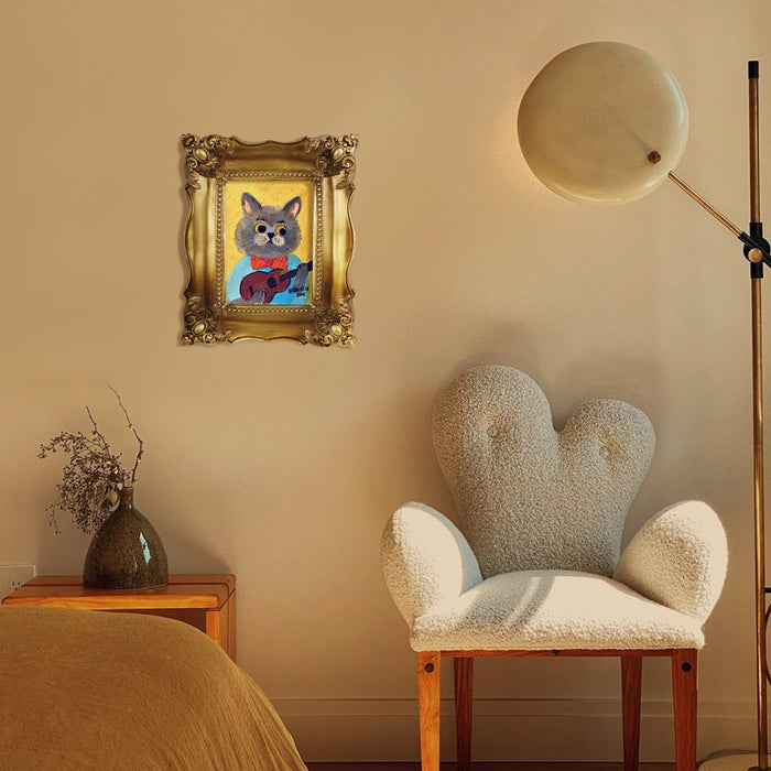 Decorative gold picture frame with intricate patterns hanging on a wall.