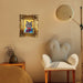 Decorative gold picture frame with intricate patterns hanging on a wall.