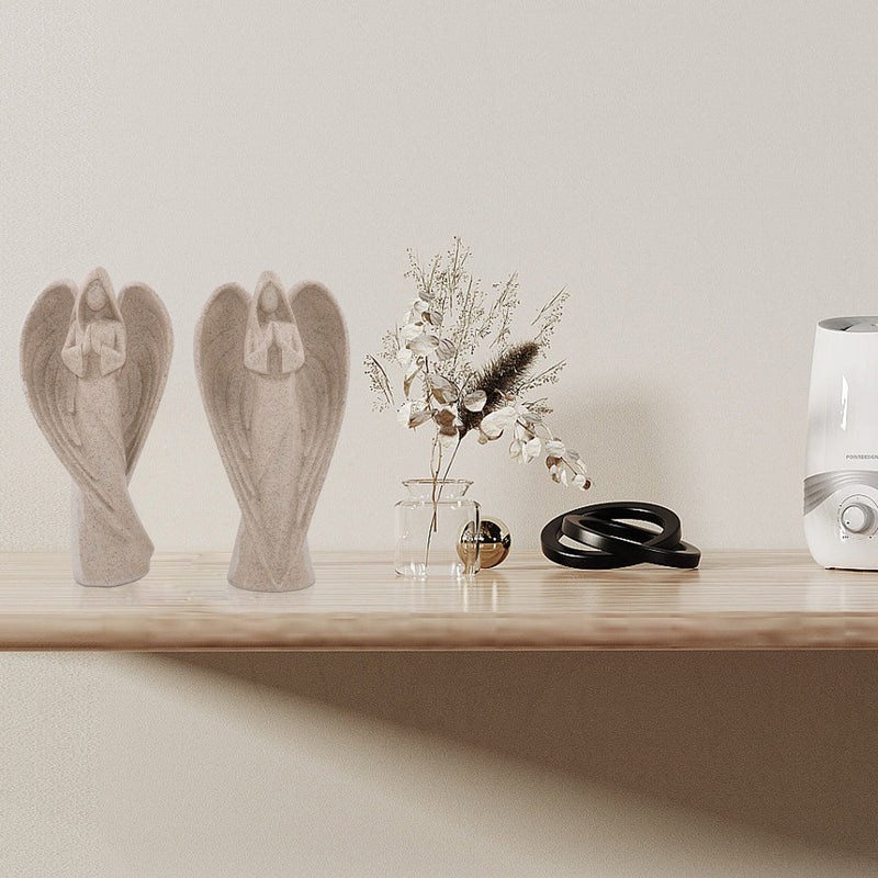 Decorative items including angel statues, a vase with flowers, and a humidifier on a wooden shelf.