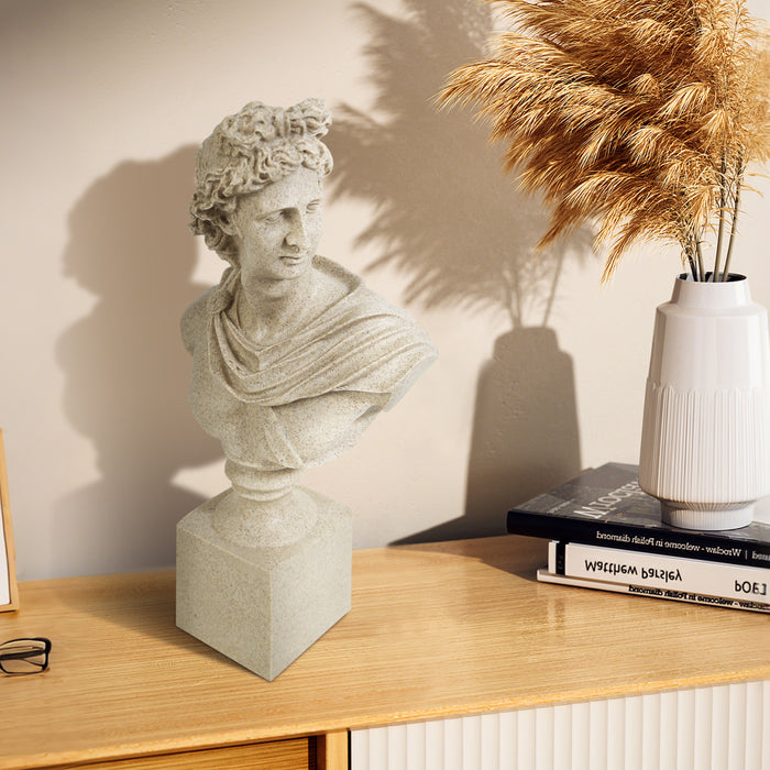 Statue bust on a wooden surface with books and a vase in the background.