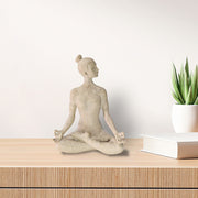 A beige yoga lady statue in a meditation pose, 9.5 inches tall, with a textured surface resembling sandstone.