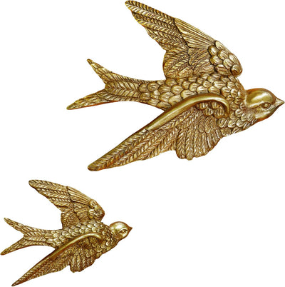 Two gold bird figurines on a white background.