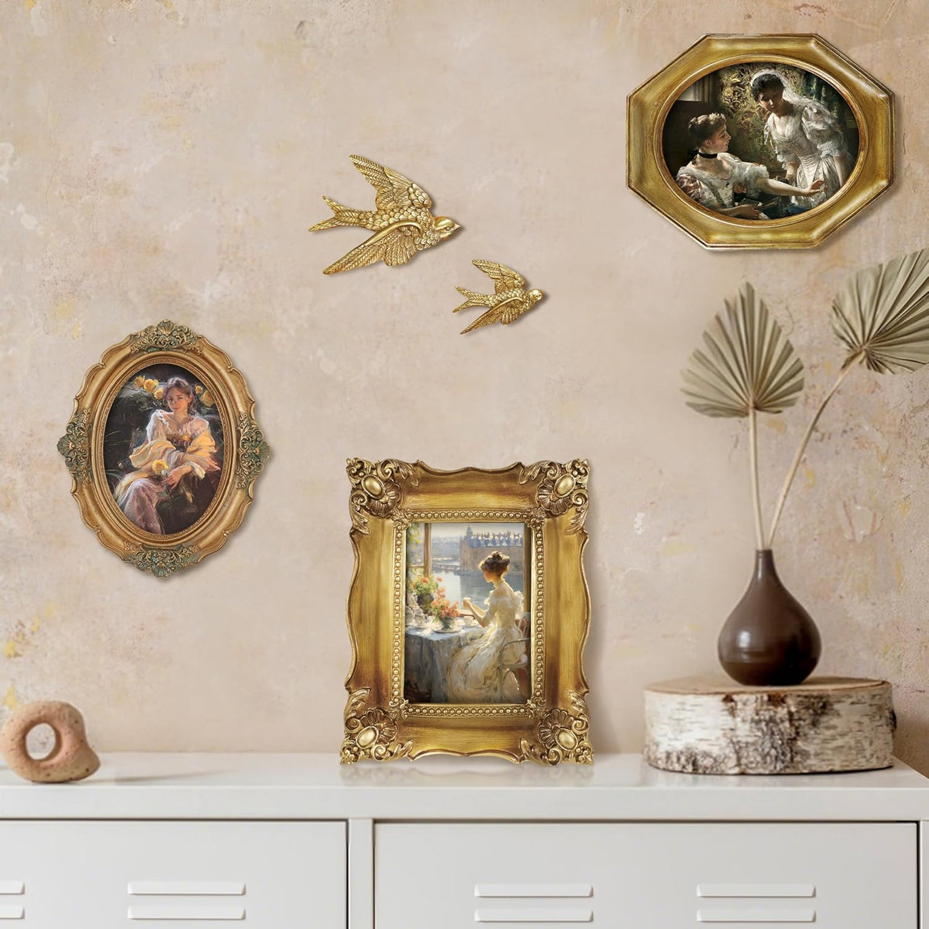 Decorative wall with gold-framed artworks and wall art on a beige wall.