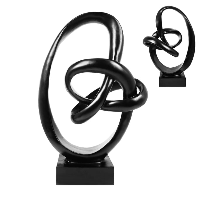 Black abstract sculpture on a white background.