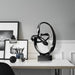 Black abstract sculpture on a white background.