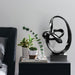 Black abstract sculpture on a white background.