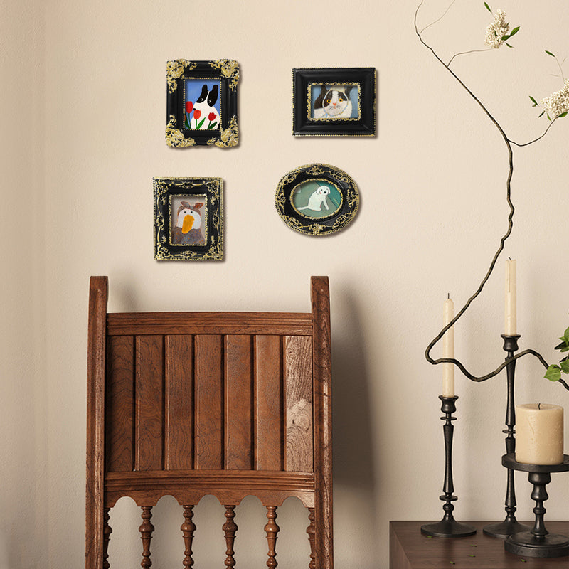 Decorative wall with framed pictures of animals, a wooden chair, and candle holders.