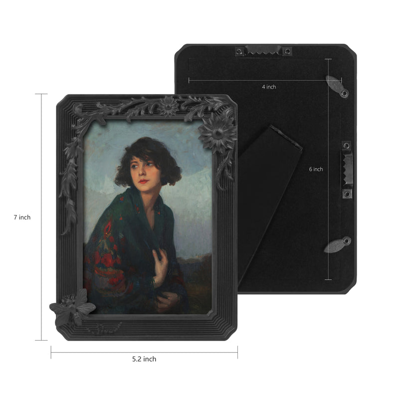 Black vintage 4x6 picture frame with hand-carved butterfly and flower border displayed in home décor setting