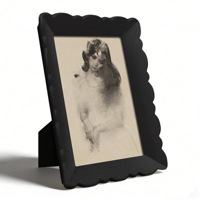 Vintage-style black frame with a nude portrait on a white background