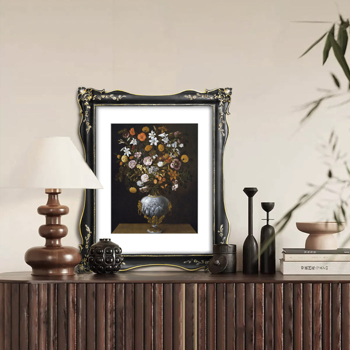 An ornate black picture frame with floral carvings around the border, designed for an 11x14 poster.