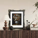 An ornate black picture frame with floral carvings around the border, designed for an 11x14 poster.