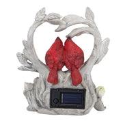 Decorative garden sculpture of two red birds on a branch with a solar panel.