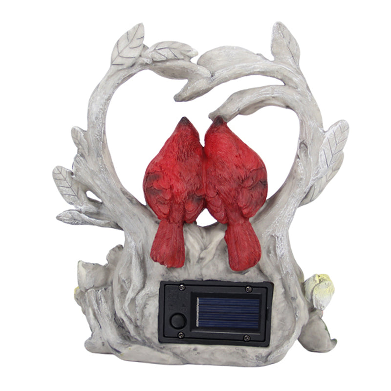 Decorative garden sculpture of two red birds on a branch with a solar panel.