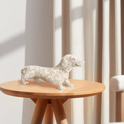 White dachshund statue, beautifully crafted in resin with charming details of paper-cutting style carving.