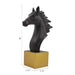 A dark brown horse sculpture standing on a solid golden base.
