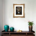 Framed artwork above a wooden console table with decorative items.