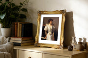 Framed portrait on a wooden table with books and decorative items