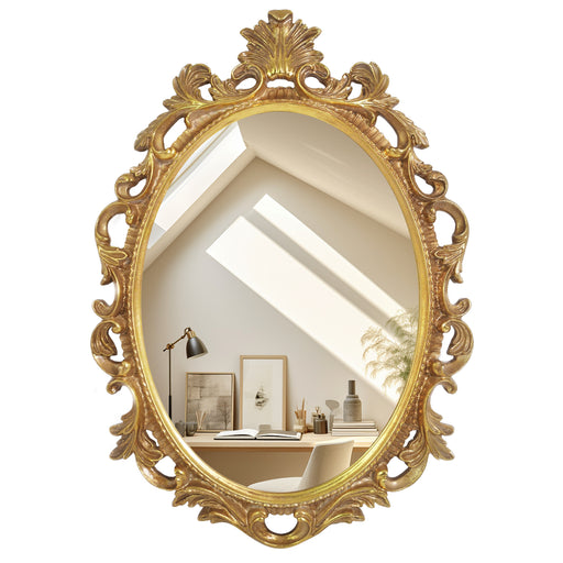 An oval mirror with a scroll design in an antique gold finish, reflecting a well-lit interior room.