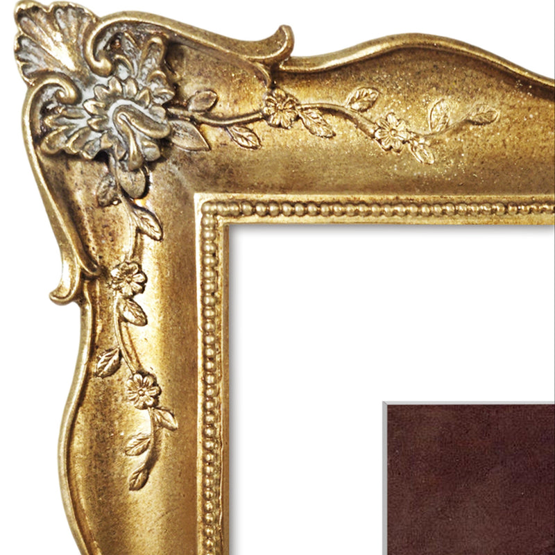 Decorative gold picture frame with intricate designs on a white background