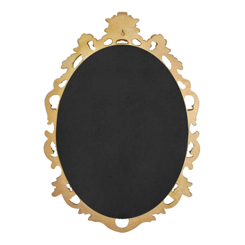 An oval mirror with a scroll design in an antique gold finish, reflecting a well-lit interior room.