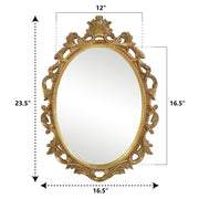 An oval mirror with a scroll design in an antique gold finish, reflecting a well-lit interior room.