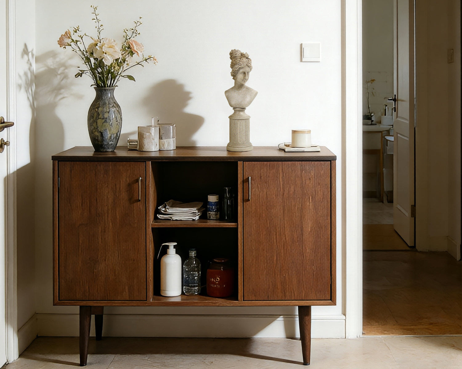 Wooden sideboard with decorative items in a room setting