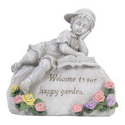 Statue of a child reading a book with flowers and 'Welcome to our happy garden' text on a white background