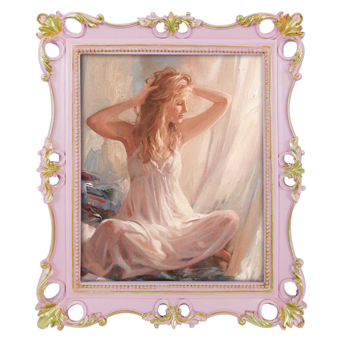 An ornate vintage-inspired picture frame with pink edges and gold accents, designed for an 8x10-inch picture, featuring a decorative painting of a woman inside.