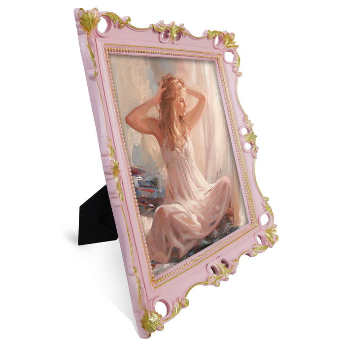 An ornate vintage-inspired picture frame with pink edges and gold accents, designed for an 8x10-inch picture, featuring a decorative painting of a woman inside.